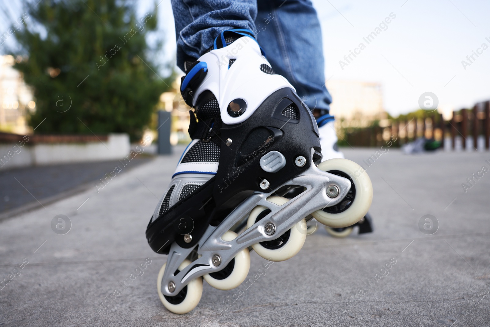 Man roller skating on city street, closeup Photo of Man roller skating on city street, closeup
