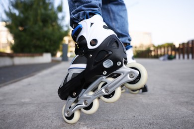 Photo of Man roller skating on city street, closeup