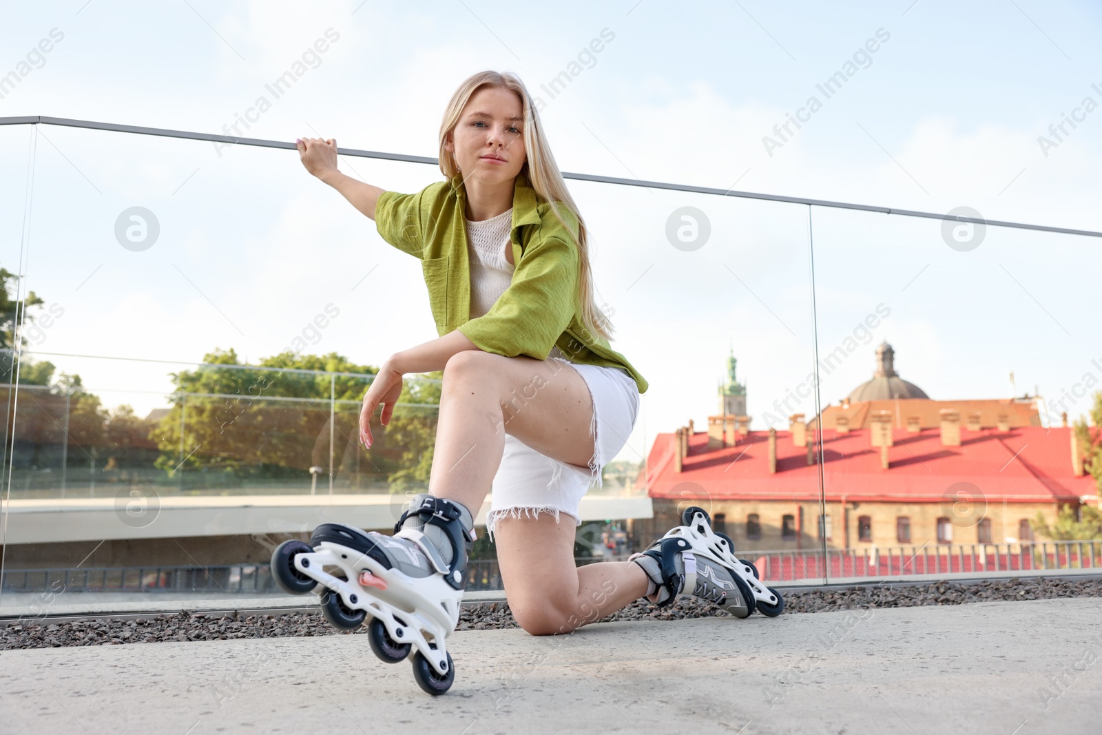 Photo of Happy woman with roller skates on street