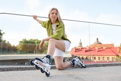 Photo of Happy woman with roller skates on street