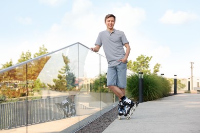 Photo of Happy man roller skating on city street