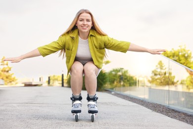 Photo of Happy woman roller skating on city street