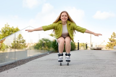 Photo of Happy woman roller skating on city street