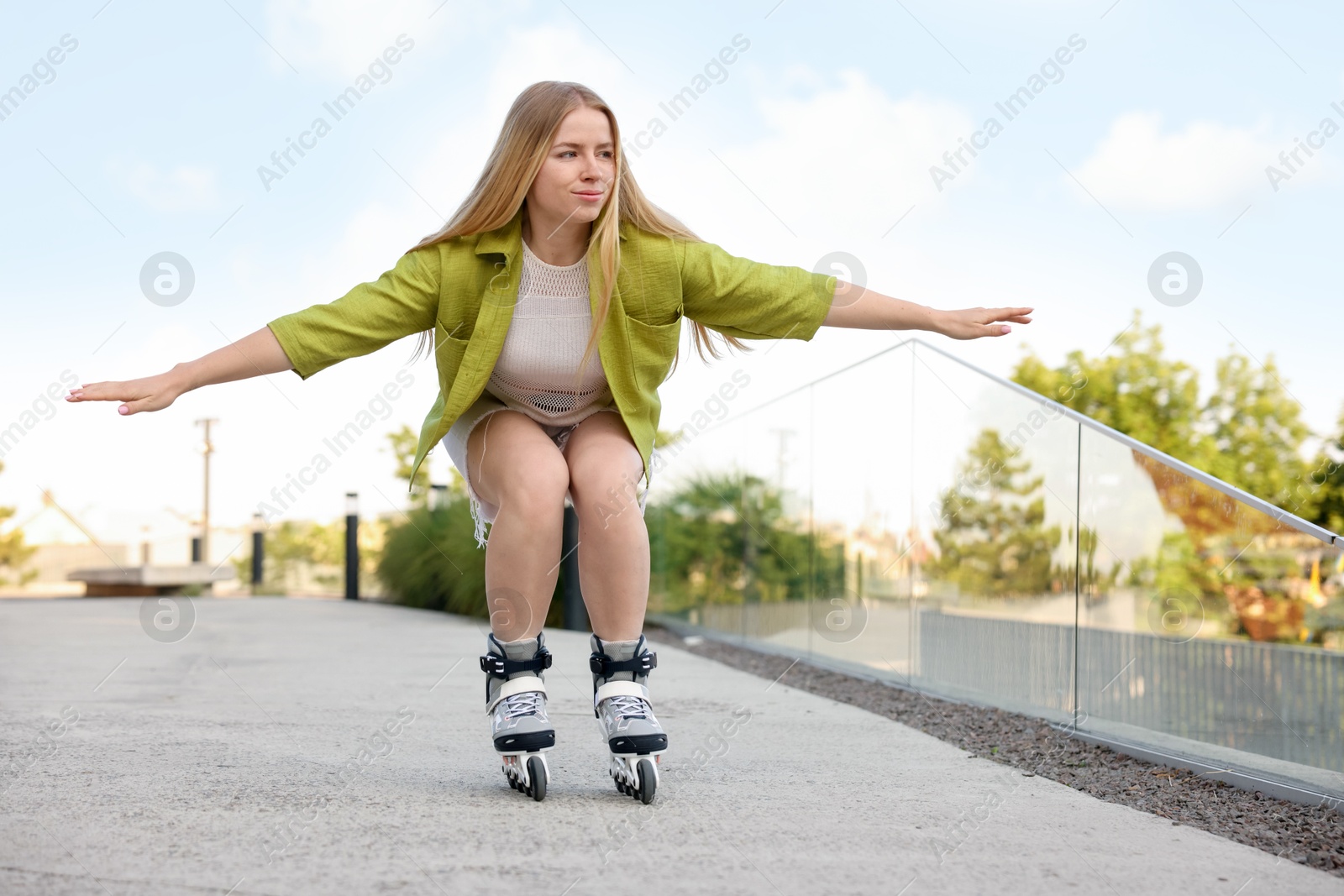Photo of Happy woman roller skating on city street