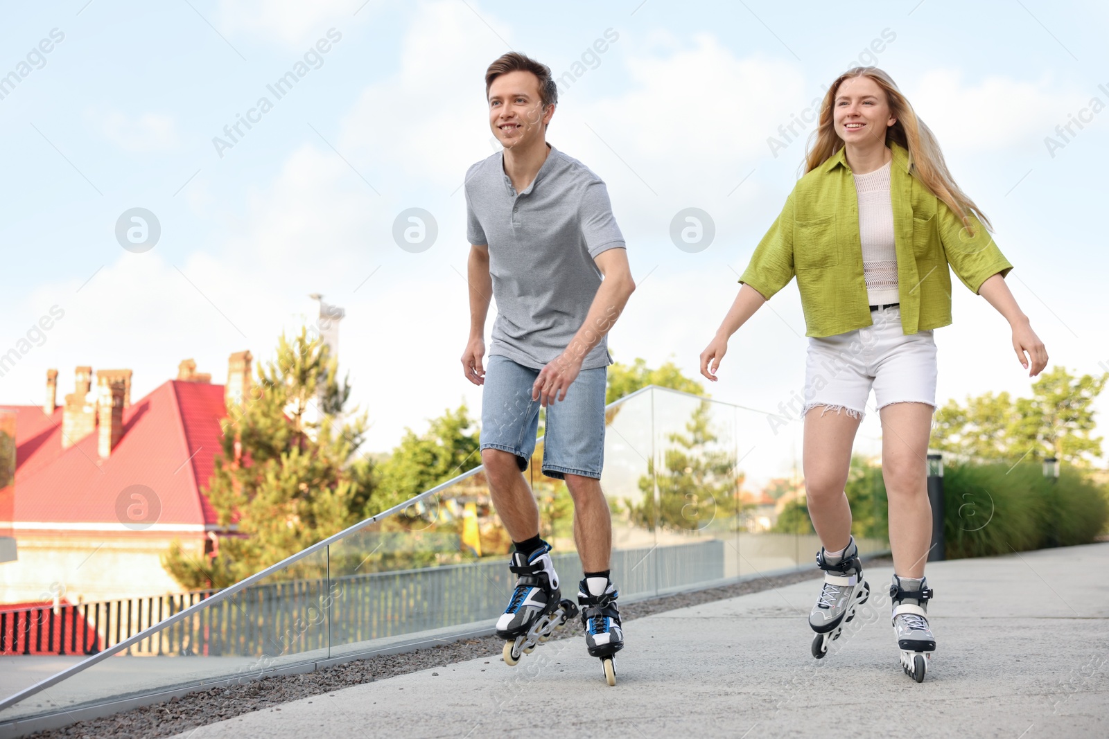 Photo of Happy couple roller skating together on street