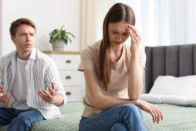 Photo of Woman and man fighting on bed at home