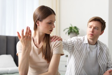 Photo of Woman and man having quarrel at home, selective focus