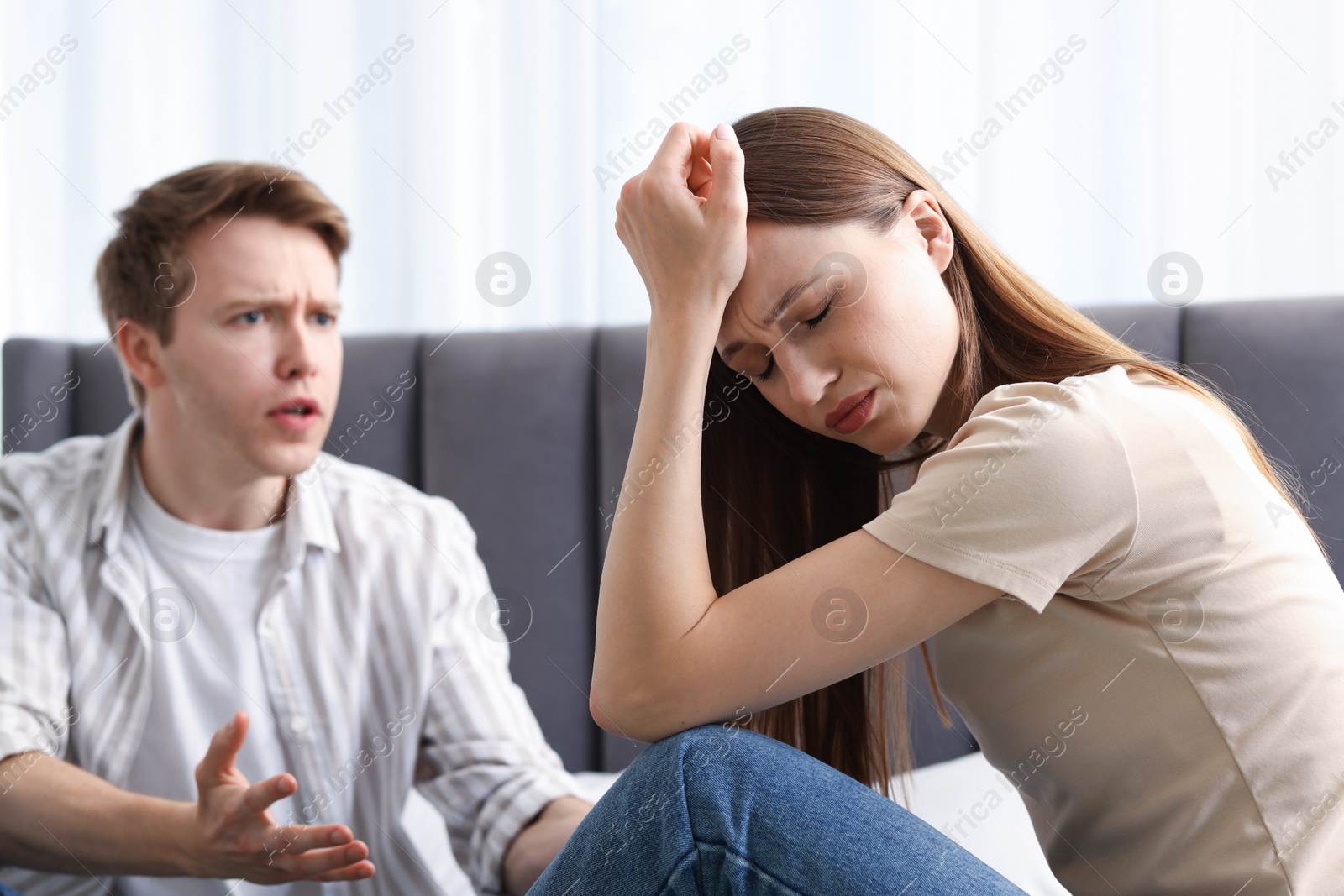 Woman and man fighting on bed at home, selective focus Photo of Woman and man fighting on bed at home, selective focus