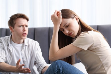 Photo of Woman and man fighting on bed at home, selective focus
