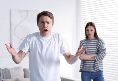 Photo of Woman and man having fight at home, selective focus