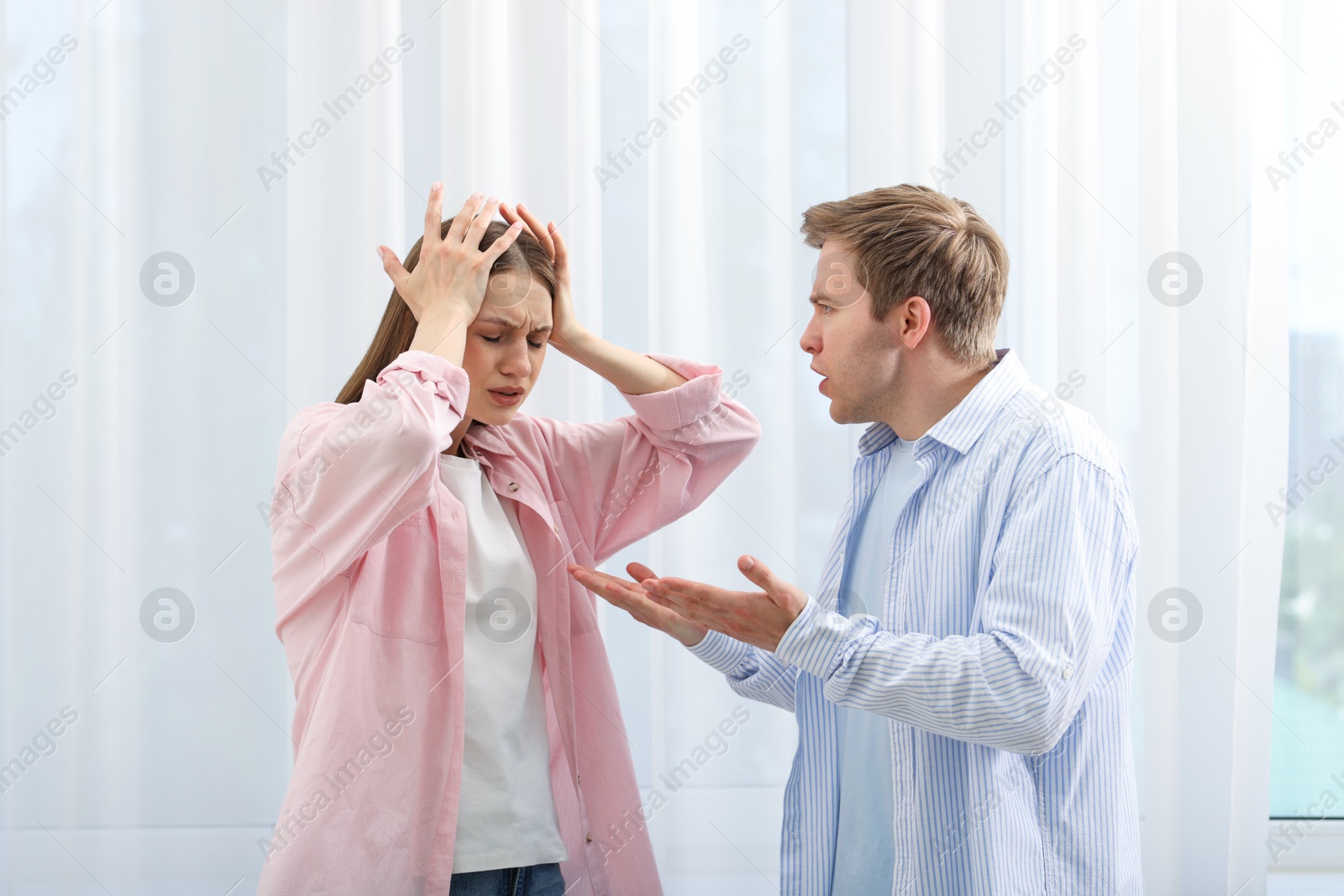 Photo of Woman and man having quarrel at home