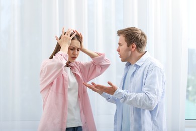 Photo of Woman and man having quarrel at home