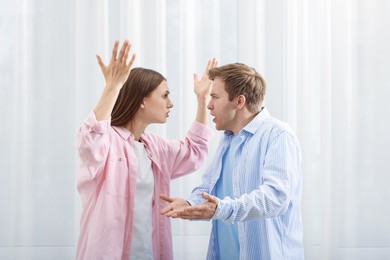 Photo of Woman and man having quarrel at home