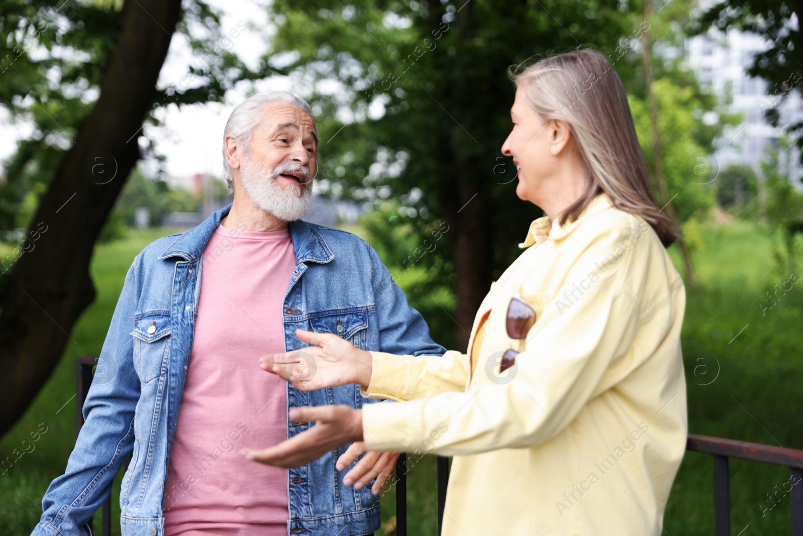 Lovely senior couple walking together in park Photo of Lovely senior couple walking together in park
