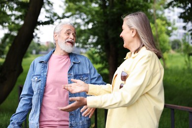 Photo of Lovely senior couple walking together in park