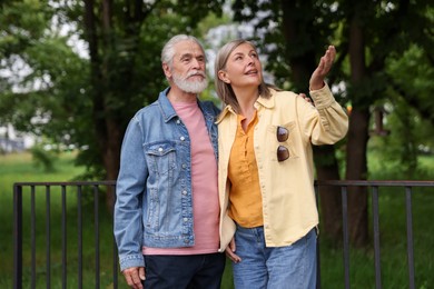 Photo of Lovely senior couple walking together in park