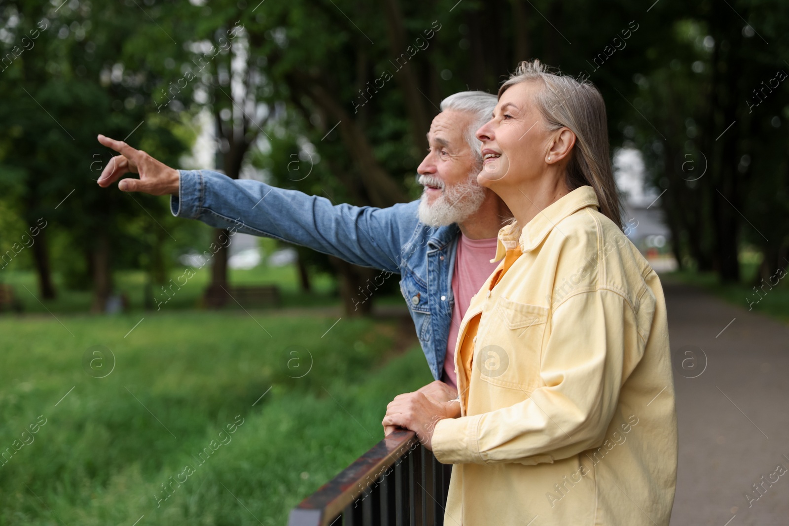 Photo of Lovely senior couple walking together in park