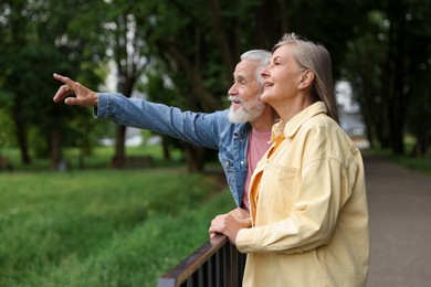 Photo of Lovely senior couple walking together in park