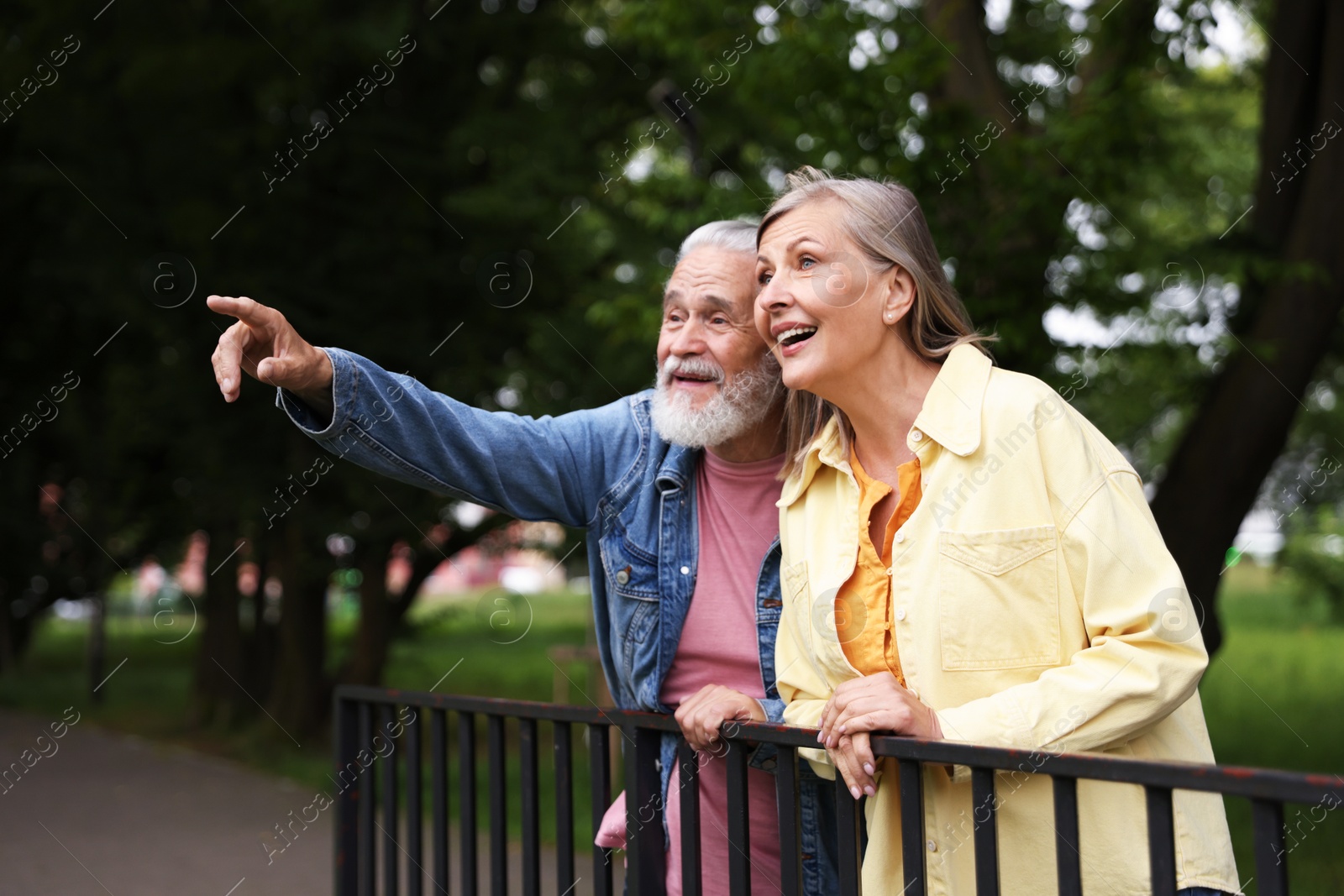 Photo of Lovely senior couple walking together in park