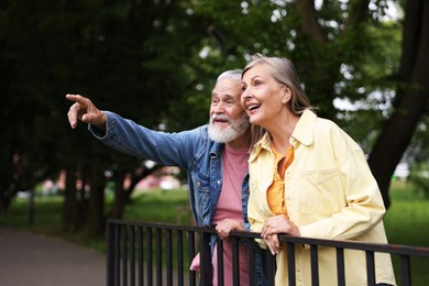 Photo of Lovely senior couple walking together in park