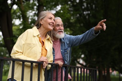 Photo of Lovely senior couple walking together in park, low angle view