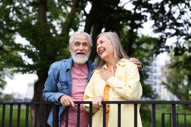 Photo of Lovely senior couple walking together in park