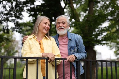 Photo of Lovely senior couple walking together in park