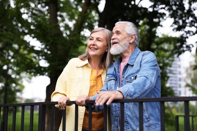 Photo of Lovely senior couple walking together in park