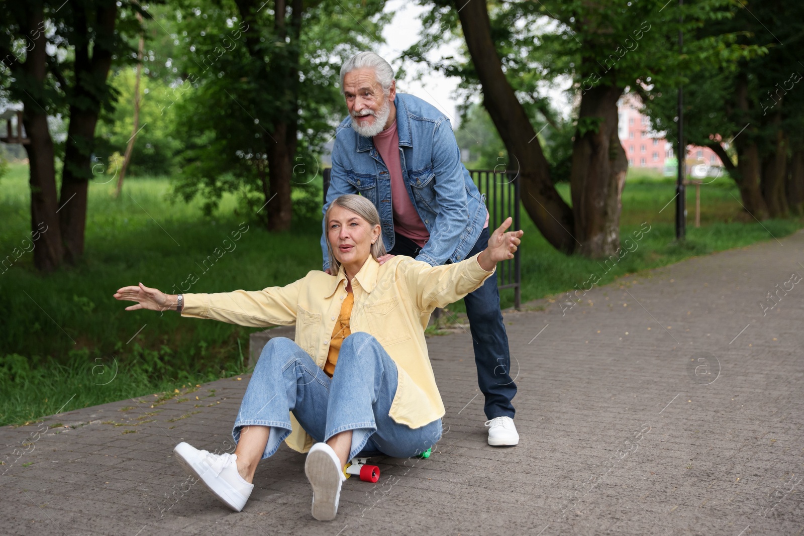 Lovely senior couple having fun together in park, space for text Photo of Lovely senior couple having fun together in park, space for text