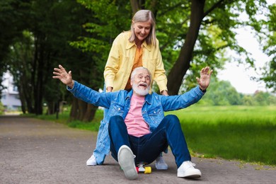 Photo of Lovely senior couple having fun together in park
