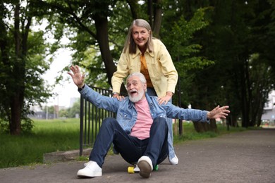 Photo of Lovely senior couple having fun together in park
