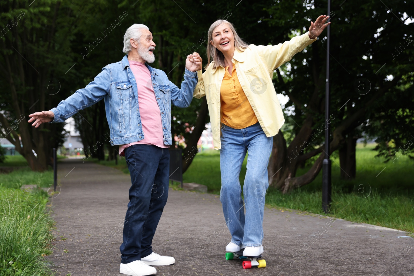Lovely senior couple having fun together in park Photo of Lovely senior couple having fun together in park