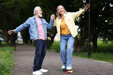 Photo of Lovely senior couple having fun together in park