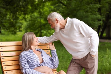 Photo of Lovely senior couple spending time together in park