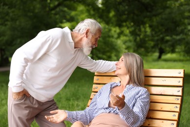 Photo of Lovely senior couple spending time together in park