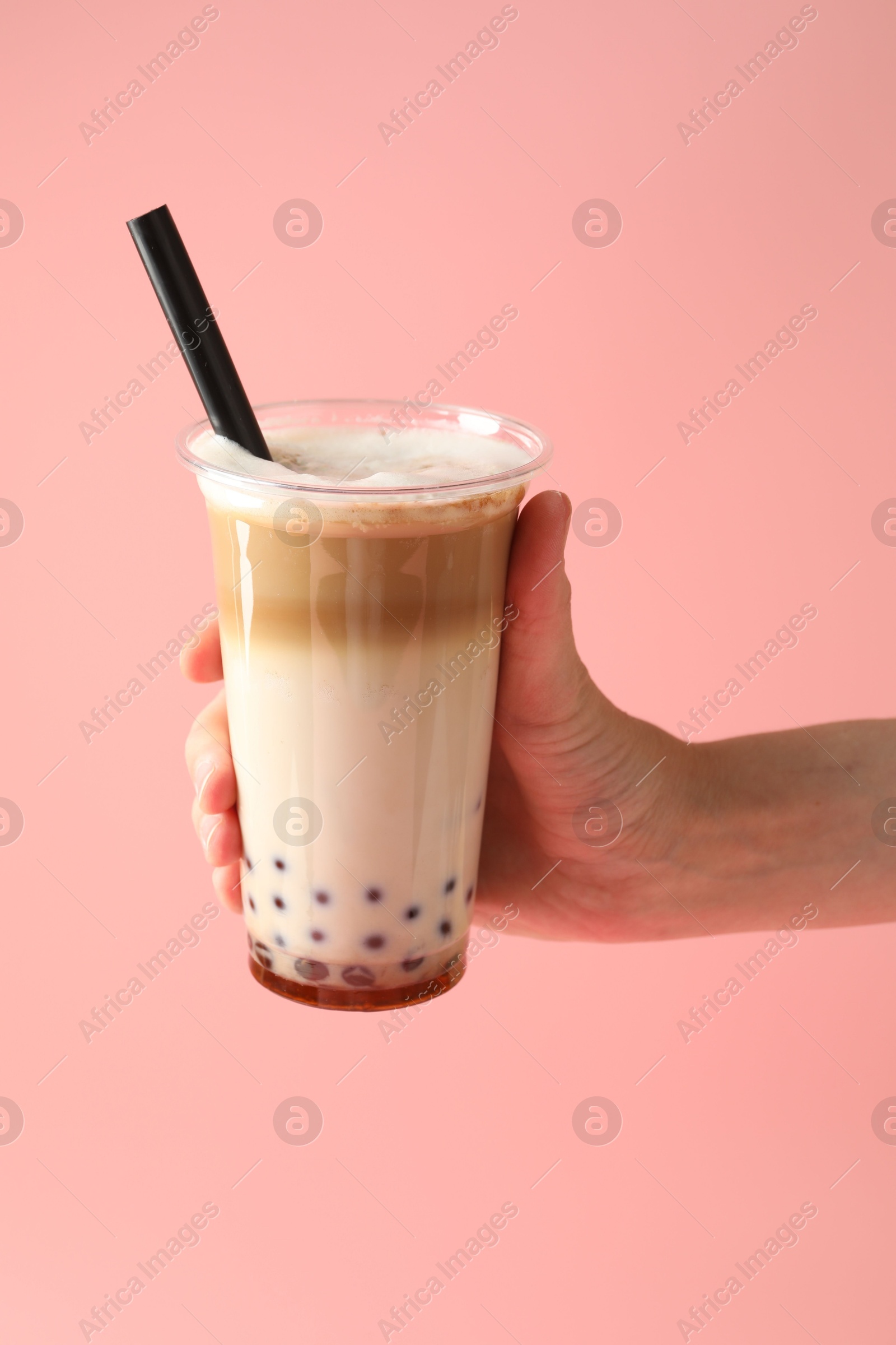 Woman with tasty milk bubble tea on pink background, closeup Photo of Woman with tasty milk bubble tea on pink background, closeup