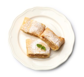 Photo of Pieces of tasty apple strudel with powdered sugar and mint isolated on white, top view