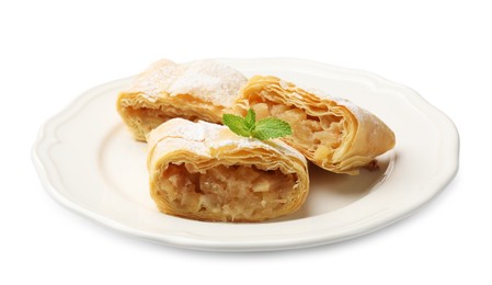 Photo of Pieces of tasty apple strudel with powdered sugar and mint isolated on white