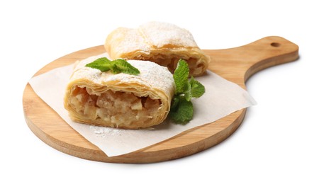 Photo of Pieces of tasty apple strudel with powdered sugar and mint isolated on white