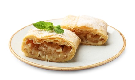 Photo of Pieces of tasty apple strudel with powdered sugar and mint isolated on white