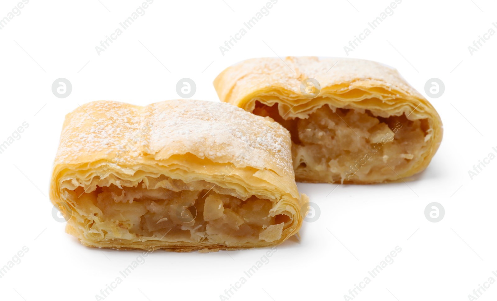 Pieces of tasty apple strudel with powdered sugar isolated on white Photo of Pieces of tasty apple strudel with powdered sugar isolated on white