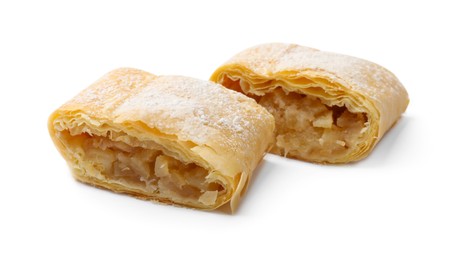 Photo of Pieces of tasty apple strudel with powdered sugar isolated on white