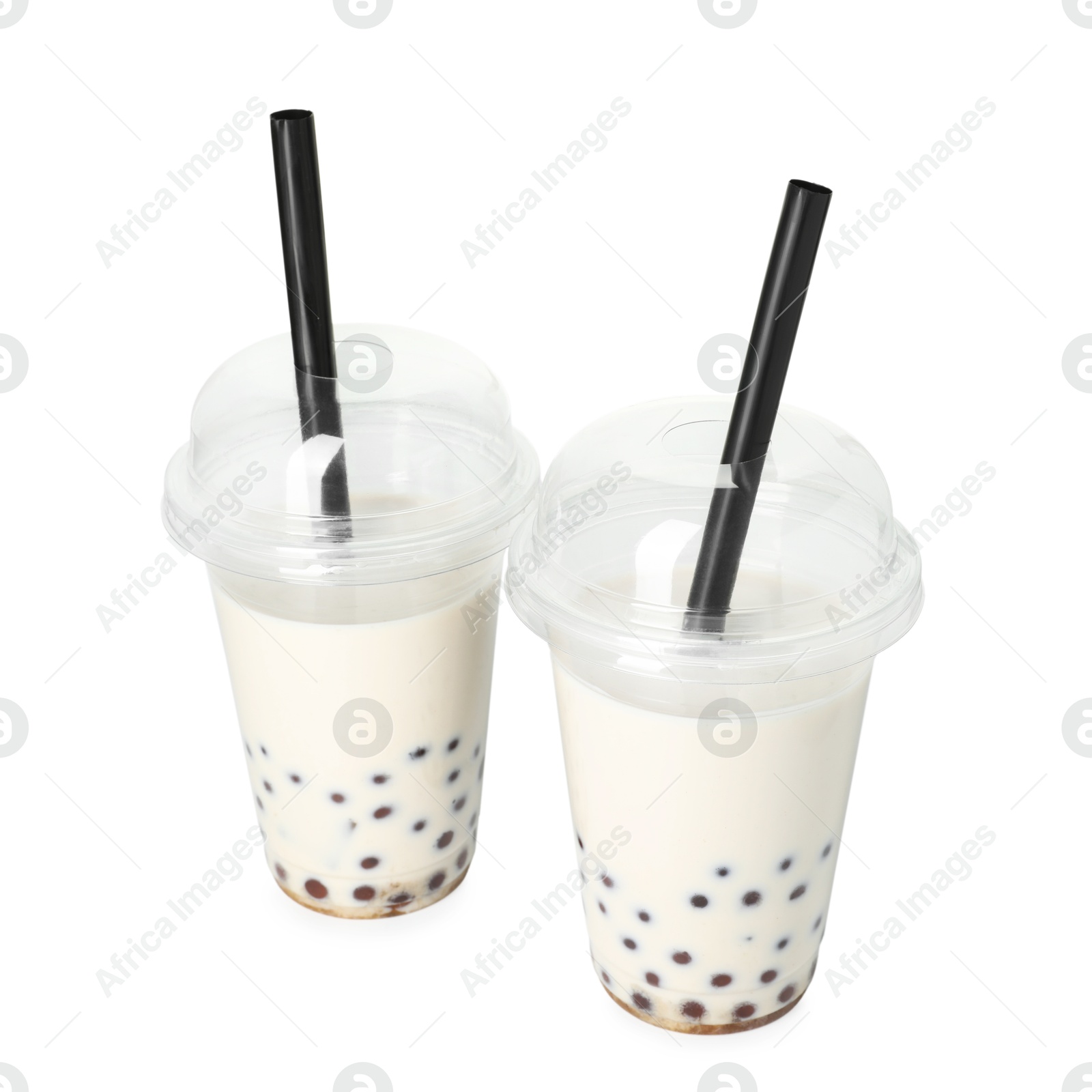 Tasty milk bubble tea in plastic cups isolated on white Photo of Tasty milk bubble tea in plastic cups isolated on white