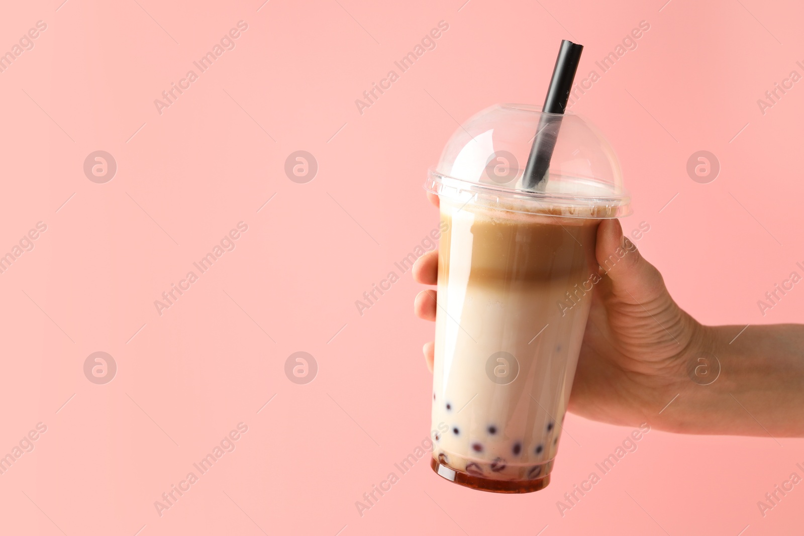 Woman with tasty milk bubble tea on pink background, closeup. Space for text Photo of Woman with tasty milk bubble tea on pink background, closeup. Space for text