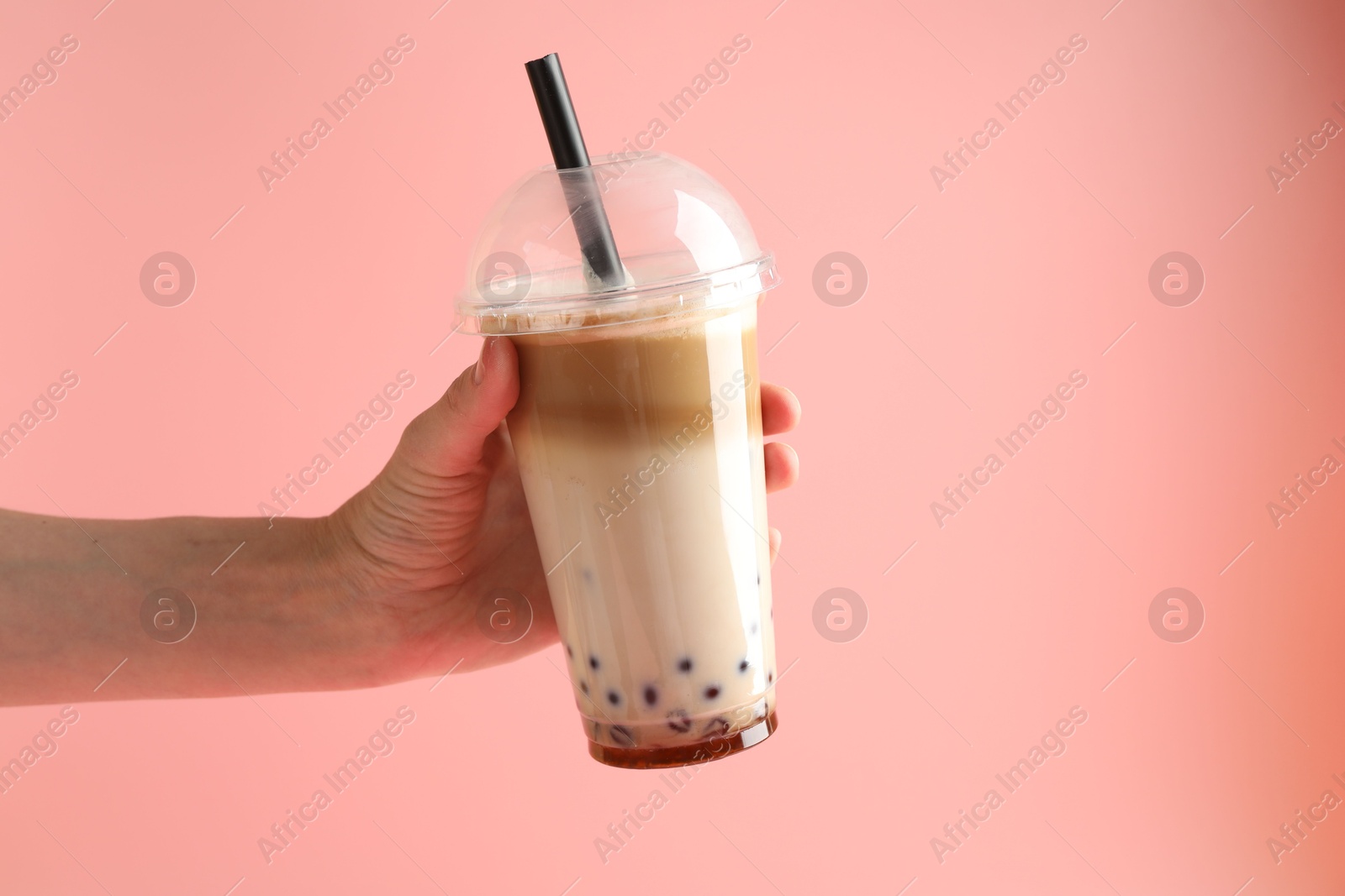 Woman with tasty milk bubble tea on pink background, closeup Photo of Woman with tasty milk bubble tea on pink background, closeup