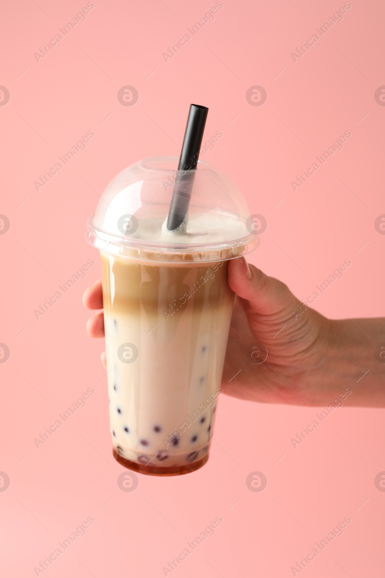 Woman with tasty milk bubble tea on pink background, closeup Photo of Woman with tasty milk bubble tea on pink background, closeup