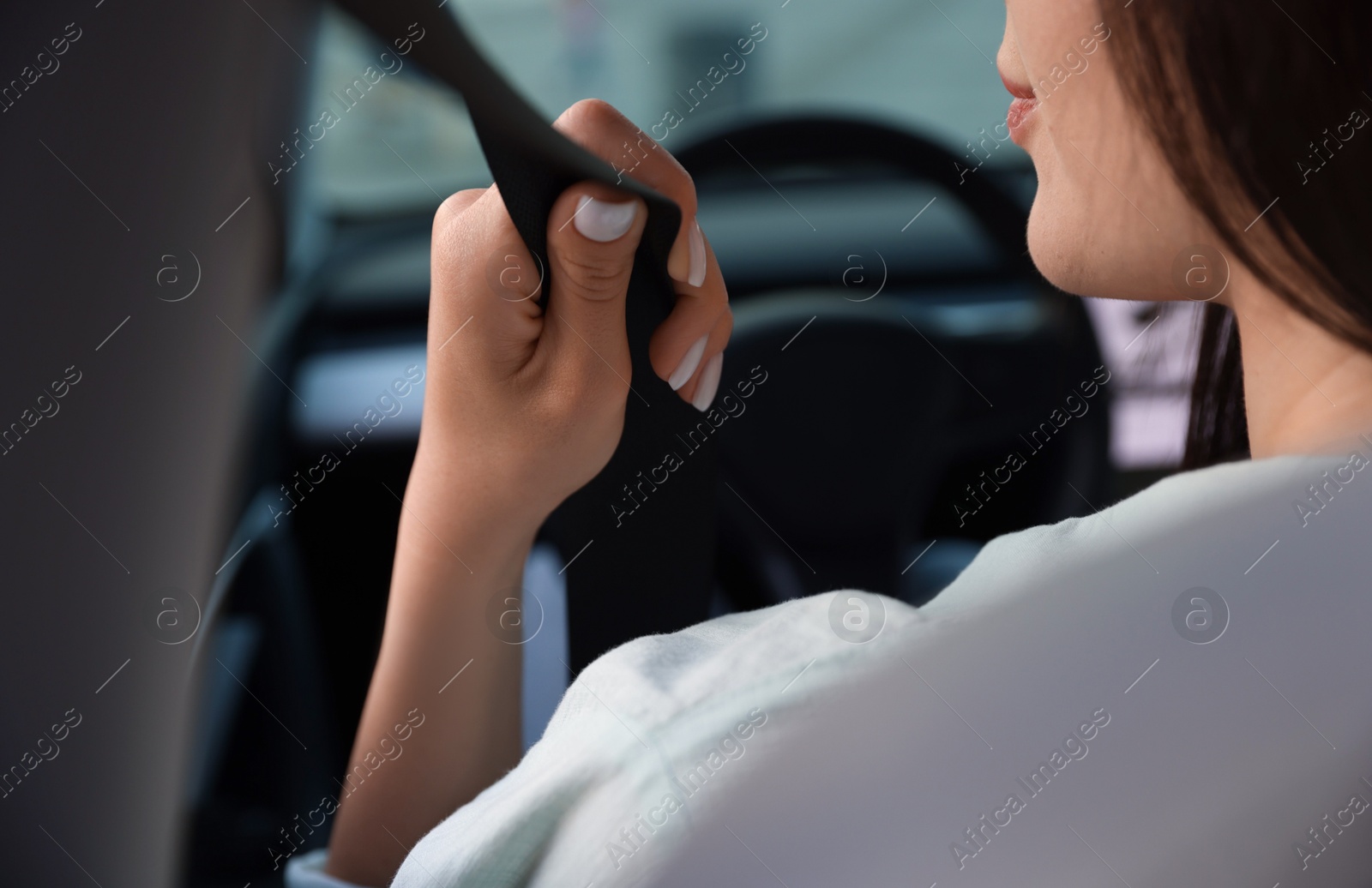 Woman with seatbelt driving car, closeup view Photo of Woman with seatbelt driving car, closeup view