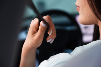 Photo of Woman with seatbelt driving car, closeup view