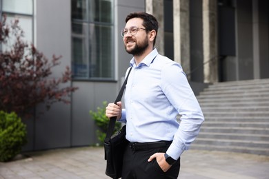 Photo of Portrait of successful businessman near office building