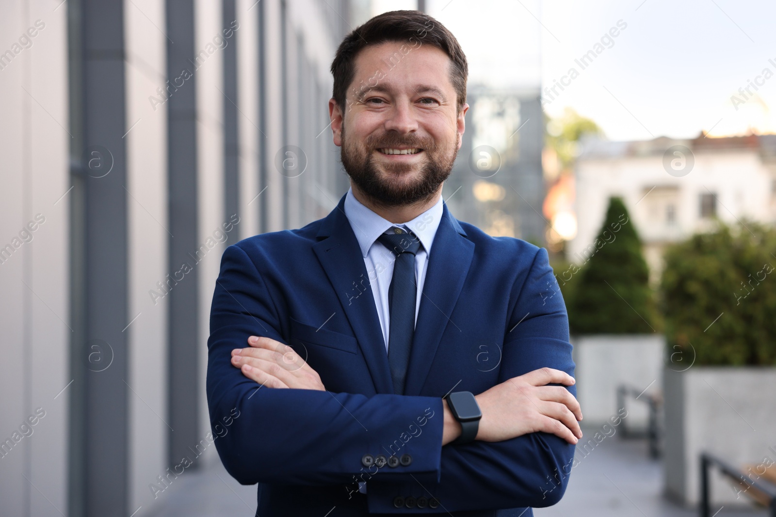 Portrait of successful businessman near office building Photo of Portrait of successful businessman near office building